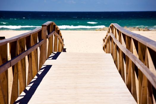 Wooden stairs on deserted beach dunes in Tarifa, Spain