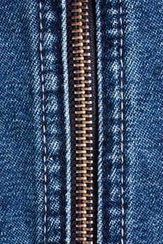 Macro shot of closed zipper on a blue jeans