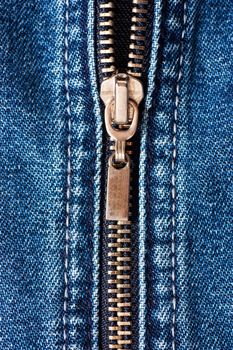 Macro shot of closed zipper on a blue jeans