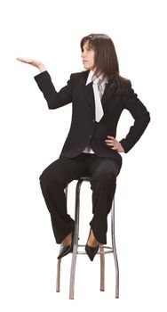 Young businesswoman sitting on a high chair and holding out her hand as if she were displaying something.You can add any text or object on the palm of her hand.