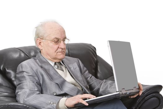 Close-up image of a senior man using a laptop.