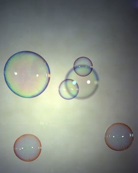 Floating colored bubbles on a grey background
