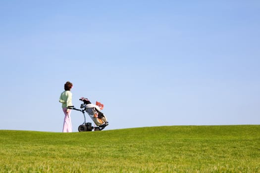 Golfer and caddy on the green