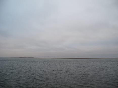 Simple dark bay water and cloudy sky