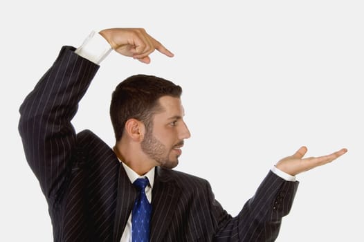 surprised businessman pointing his palm on an isolated white background