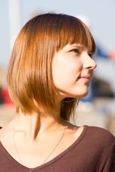 Portrait of the beautiful young girl against blue sky