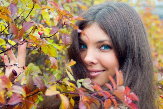 Close-up of woman eyes and autumn leaves