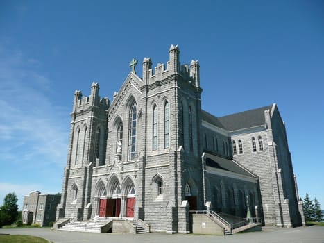 Big catholic chuch in a rural setting.