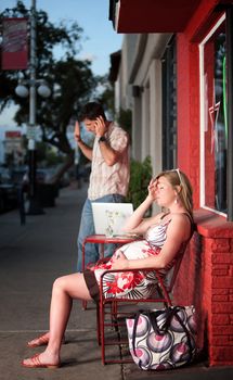 Exhausted pregnant woman annoyed with loud phone conversation
