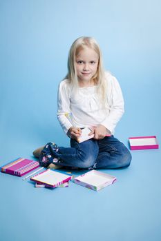 Young Girl writing on notebook 