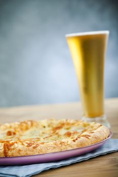 Hot pizza on the plate with cold beer