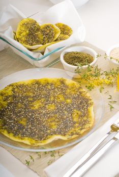 lebanese manouche or manoushe ,lebanese pizza with thyme and sesame seeds,zaatar, and extra virgin olive oil on top