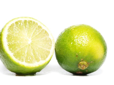 Fresh green lime fruit towards white background
