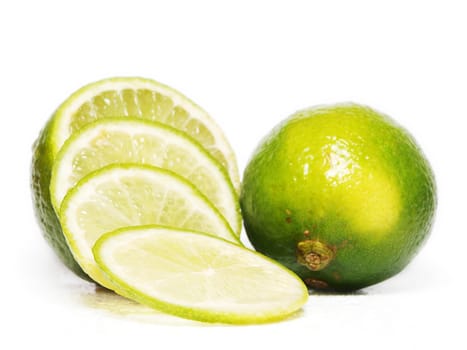 Fresh green lime fruit towards white background