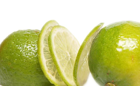 Fresh green lime fruit towards white background