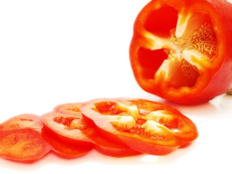 Red pepper vegetable, sliced, closeup towards white background