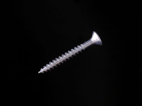 Steal wood screw on a black background.