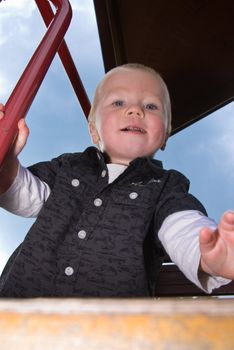 a little boy smiling cheeky into the camera