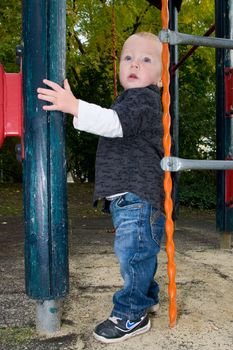 a young boy posing at the playground