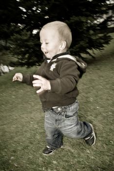 a little boy running over the lawn