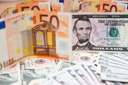 US banknotes on a fan of high-denomination european euro notes