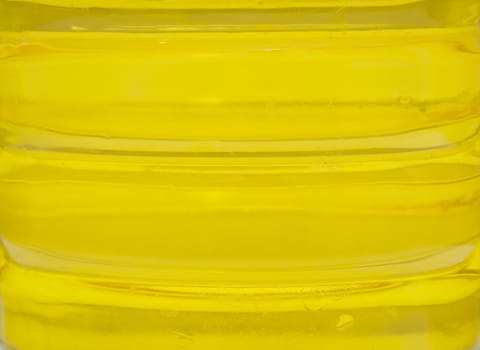 plastic bottle with yellow oil. A background, macro