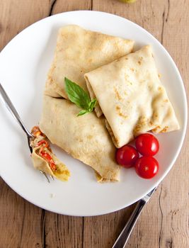 Savoury filled pancakes with basil and tomatoes