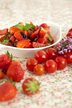 Delicious strawberry tomato salad with balsamic glaze and basil
