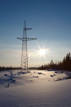 New high-voltage tower in the winter in tundra