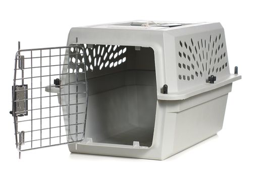 A grey cat carrier with the door open, isolated against a white background.