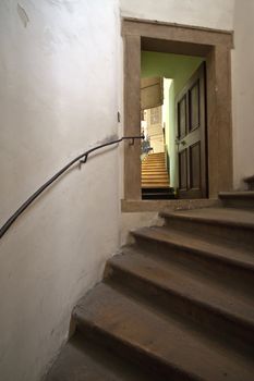 The old wooden spiral staircase with a decorative door