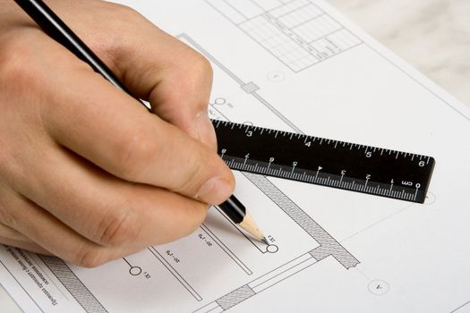 The engineering drawing on a paper. Ruler. Pencil.