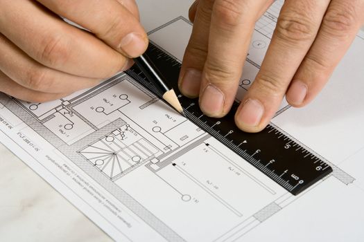 The engineering drawing on a paper. Ruler. Pencil.