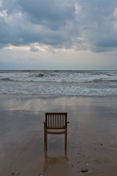 A lonely plastic chair on the beach