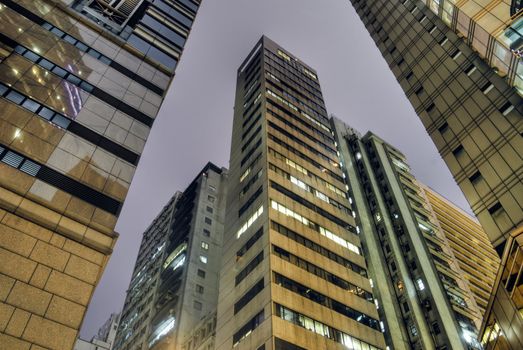 Skyscraper tower of tall in night with yellow color.