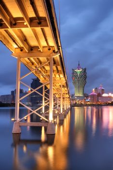 Bridge and skyscraper in night, famous landmark in Macao, China.