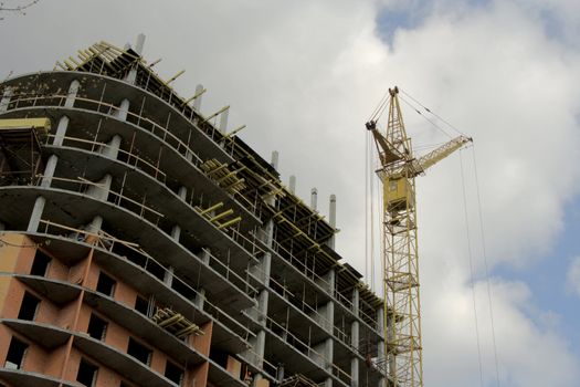 A under construction skyscraper on a background of the sky