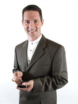 A smiling businessman in a suit holds a pda in his hand, ready to make a note.