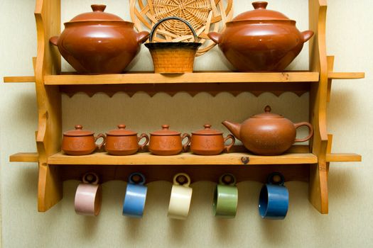 Ceramic utensils on a wooden shelf