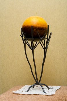 Decorative candlestick with a spherical candle