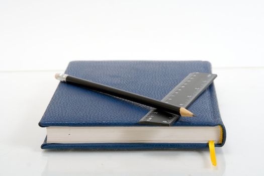 Dark blue notebook on a table. Close up.