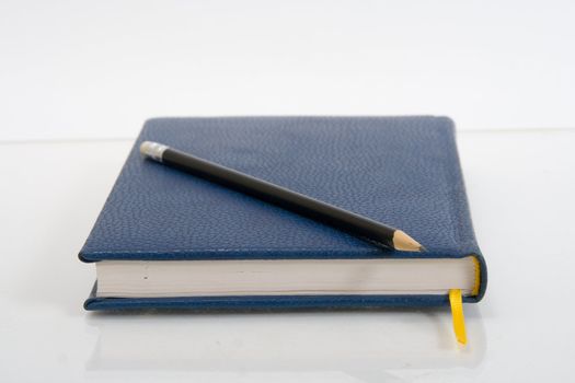 Dark blue notebook on a table. Close up.