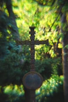 A cross in a haze of light fog and sun