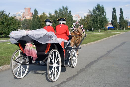 Ancient vehicle with the driver in a livery
