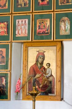 Icons in church. A burning candle.
