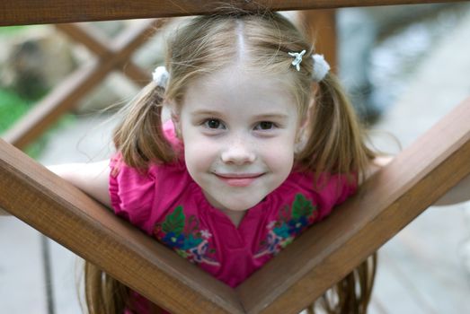 smiling little girl in a wooden structures
