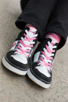 pair of Sneakers wearing on a female feet