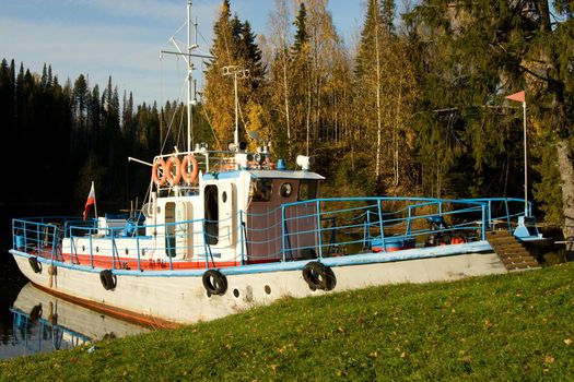 Yacht moored to coast. An autumn landscape.