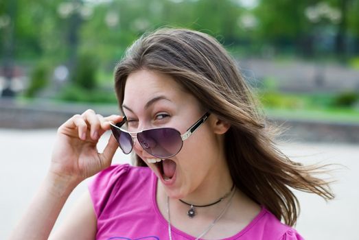 portrait of a laughing teenage girl in sunglasses