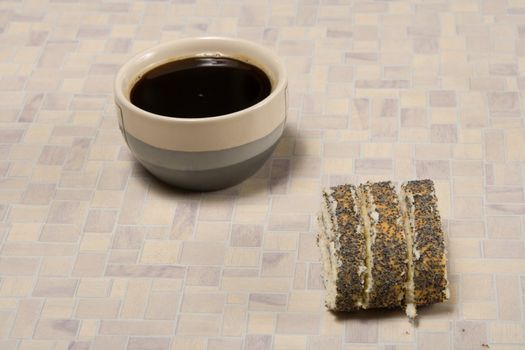 Cup of hot strong coffee with a dessert